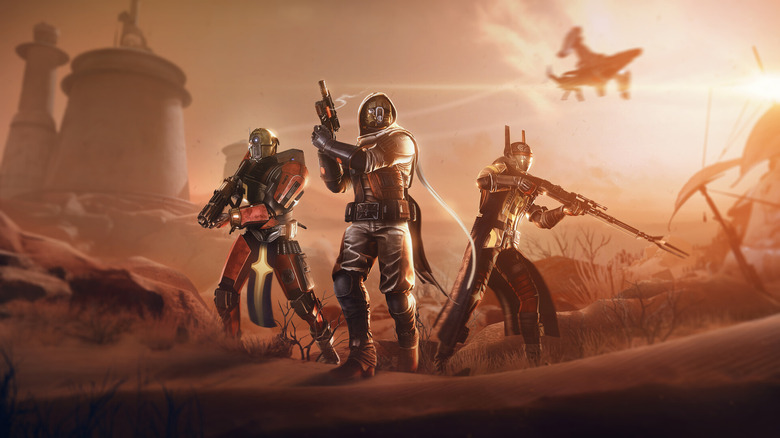 Screenshot of Destiny 2 expansion Renegades. A gold-lit trio of sci-fi Guardians stand at the center, armed for combat.